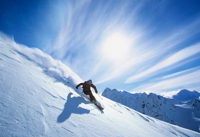person skiing down a mountain quickly