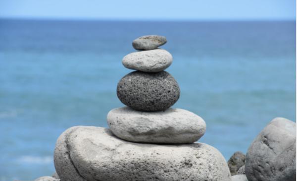 Stones neatly stacked on top of each other at a beach Stones neatly stacked on top of each other at a beach